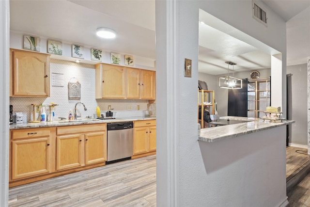 kitchen with light brown cabinetry, dishwasher, sink, and light wood-type flooring