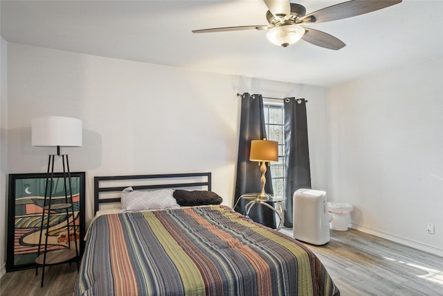 bedroom with hardwood / wood-style floors and ceiling fan