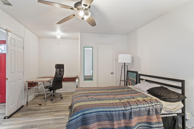 bedroom with ceiling fan and light wood-type flooring