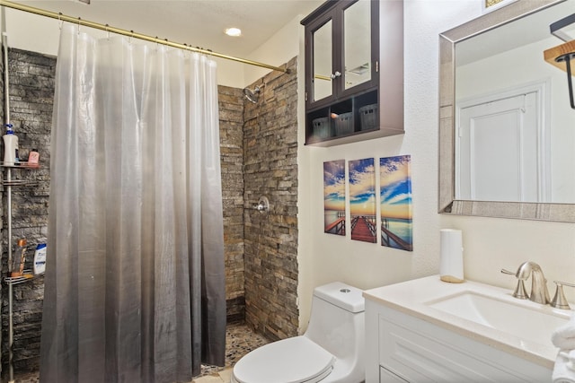 bathroom featuring vanity, toilet, and walk in shower