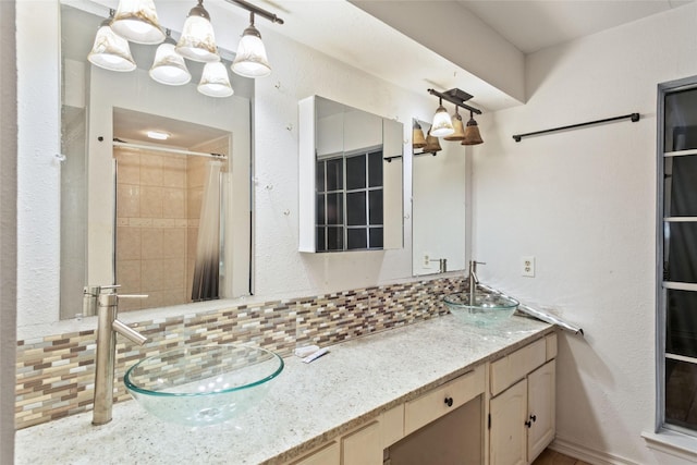 bathroom featuring decorative backsplash, vanity, and a shower with shower curtain