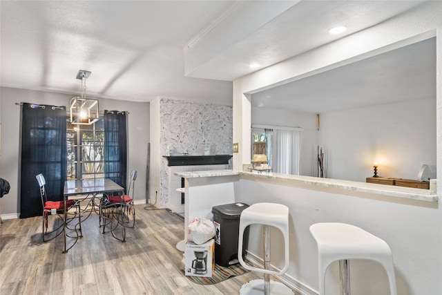 kitchen featuring pendant lighting, a healthy amount of sunlight, and wood-type flooring