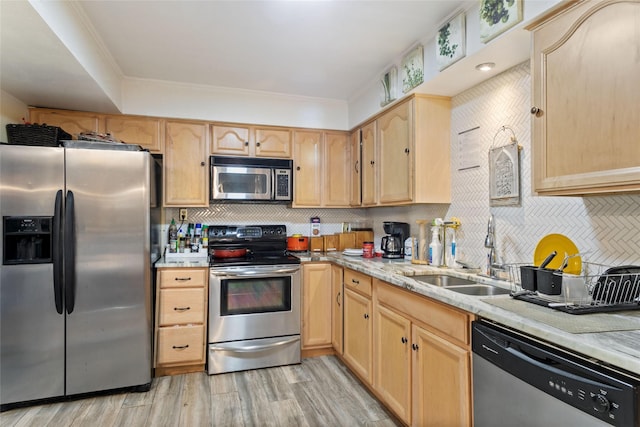 kitchen featuring sink, stainless steel appliances, light wood-type flooring, light brown cabinetry, and ornamental molding