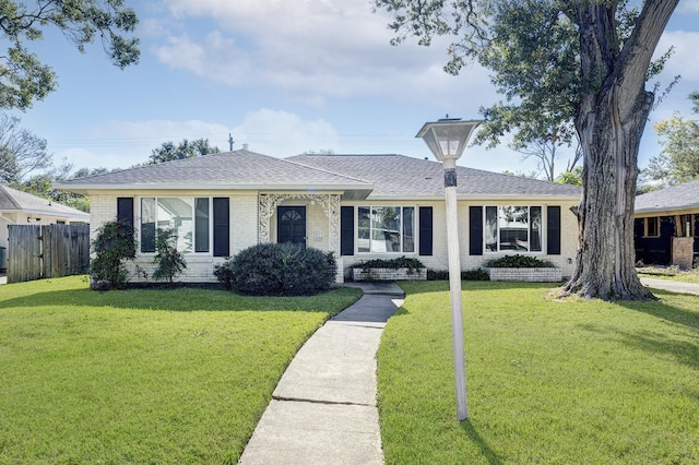 ranch-style home with a front yard