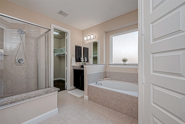 bathroom featuring tile patterned floors, vanity, and shower with separate bathtub