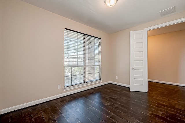 unfurnished bedroom with dark hardwood / wood-style floors and vaulted ceiling