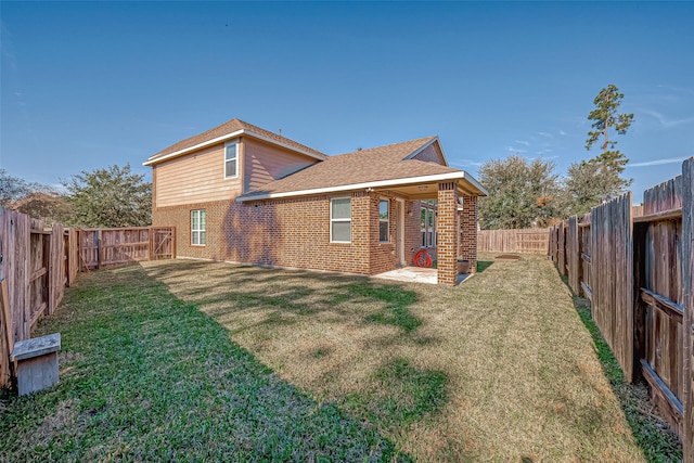 back of property featuring a patio area and a lawn