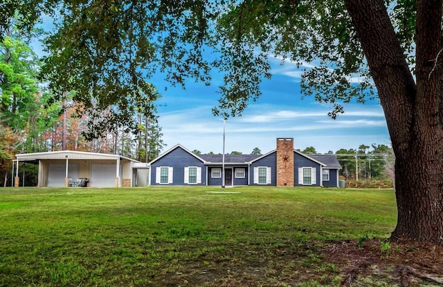 view of front of house with a front yard, a garage, and a carport