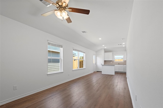 unfurnished living room featuring ceiling fan, plenty of natural light, and hardwood / wood-style floors