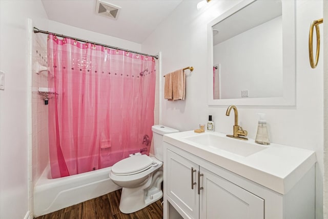 full bathroom with hardwood / wood-style floors, vanity, toilet, and shower / bathtub combination with curtain