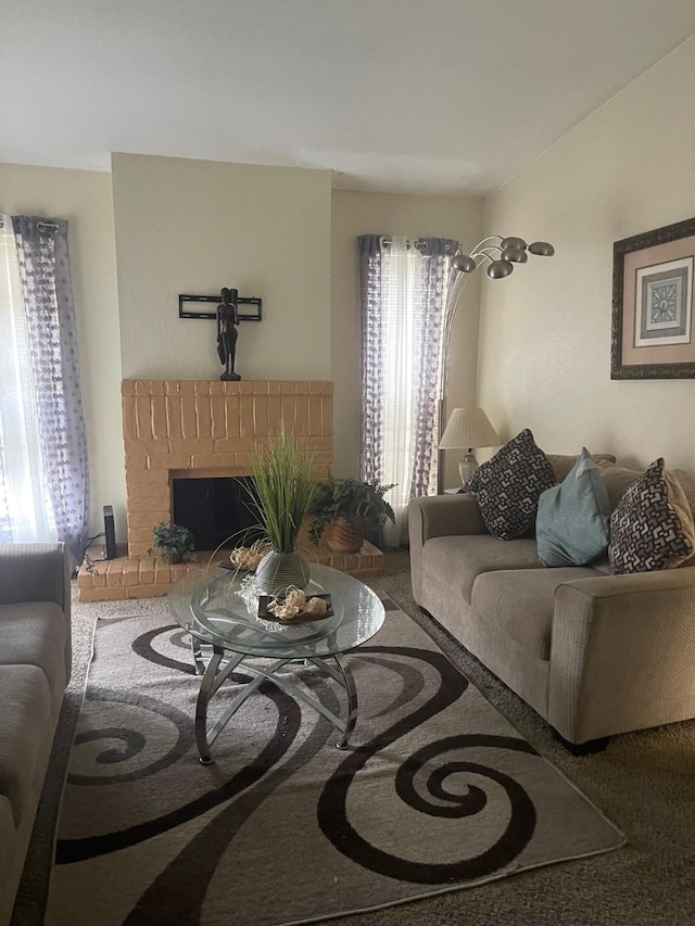 carpeted living room featuring a brick fireplace