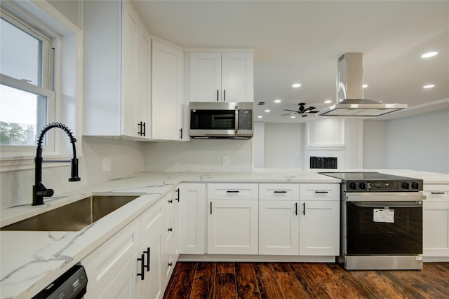 kitchen with white cabinetry, sink, dark wood-type flooring, extractor fan, and appliances with stainless steel finishes