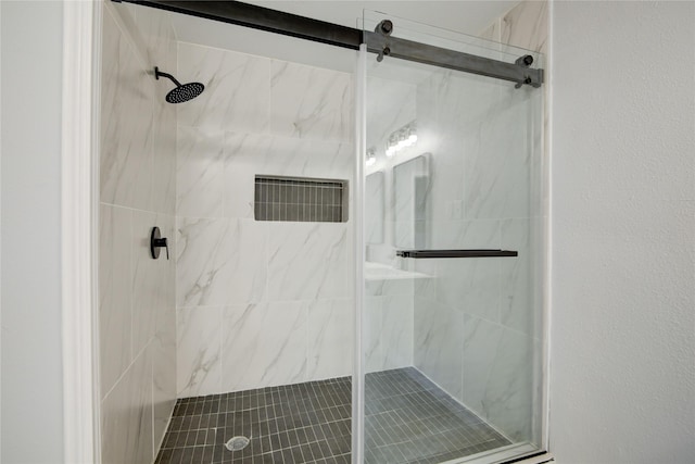 bathroom with a shower with shower door