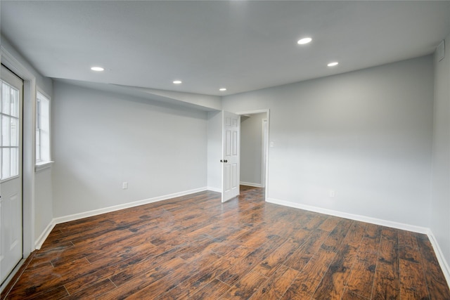 empty room with dark wood-type flooring