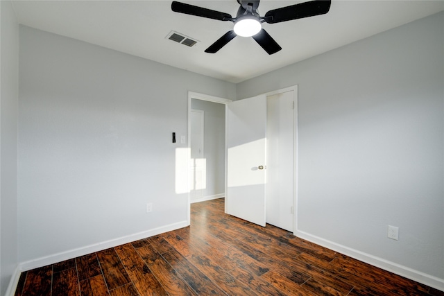 empty room featuring ceiling fan and dark hardwood / wood-style flooring