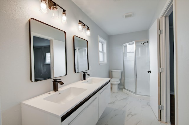 bathroom with vanity, toilet, and a shower with shower door