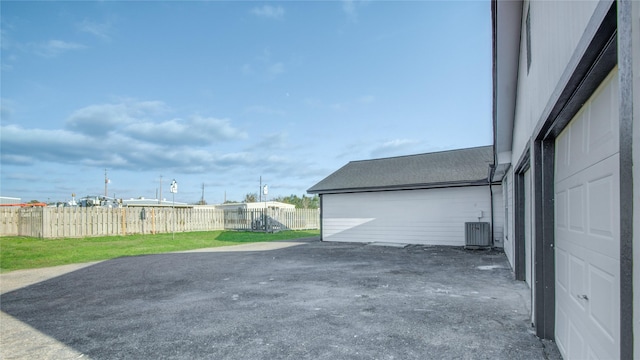 exterior space featuring a lawn and central AC