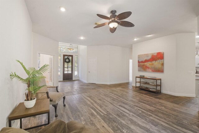 living room with ceiling fan and dark wood-type flooring