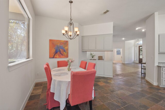 dining space with a notable chandelier and a wealth of natural light