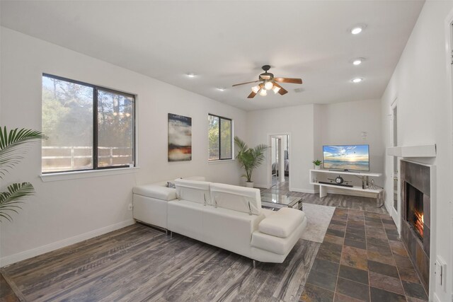 living room with ceiling fan and dark wood-type flooring