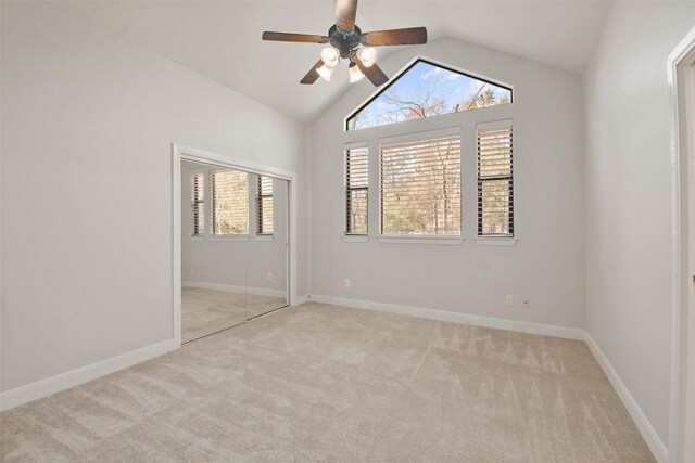 unfurnished room with light carpet, ceiling fan, and lofted ceiling