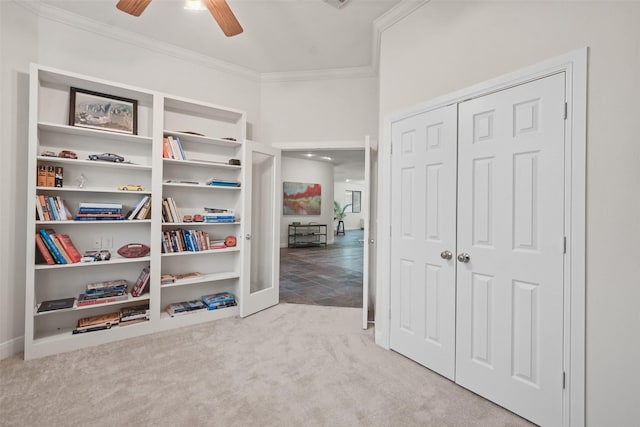 interior space with ceiling fan, ornamental molding, and a closet