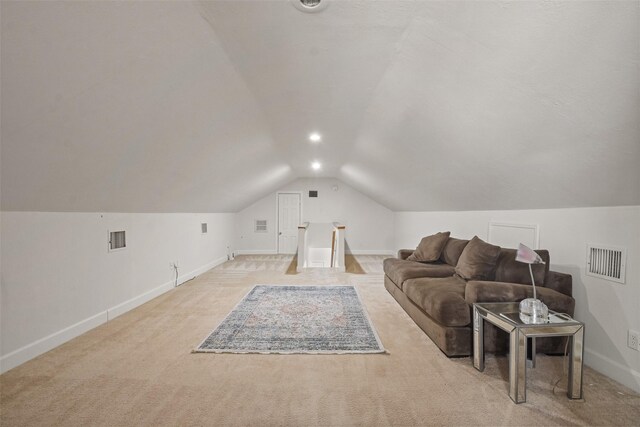 bonus room with light colored carpet and lofted ceiling