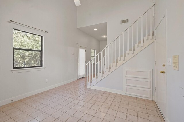 tiled entrance foyer with a high ceiling