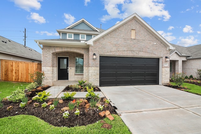 31915 Splendor Dr, Fulshear, TX 77441 - view of front of property with an attached garage, concrete driveway, brick siding, covered porch, and stone siding