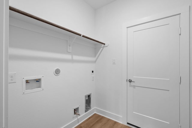 31915 Splendor Dr, Fulshear, TX 77441 - washroom featuring gas dryer hookup, wood finished floors, baseboards, hookup for an electric dryer, and washer hookup