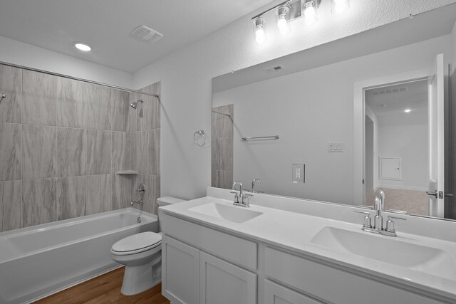 31915 Splendor Dr, Fulshear, TX 77441 - full bath with toilet, double vanity, washtub / shower combination, and wood finished floors