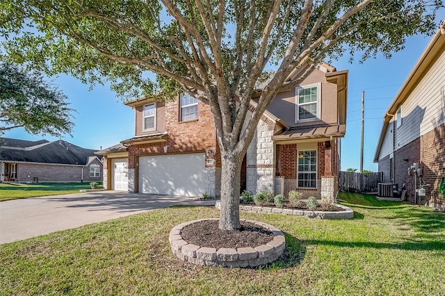 view of front of house featuring a front yard, a garage, and central AC unit