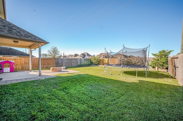 view of yard featuring a patio area and a trampoline