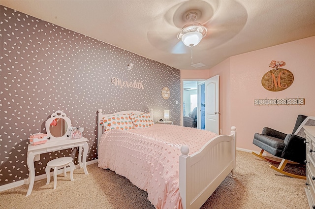 carpeted bedroom featuring a textured ceiling and ceiling fan