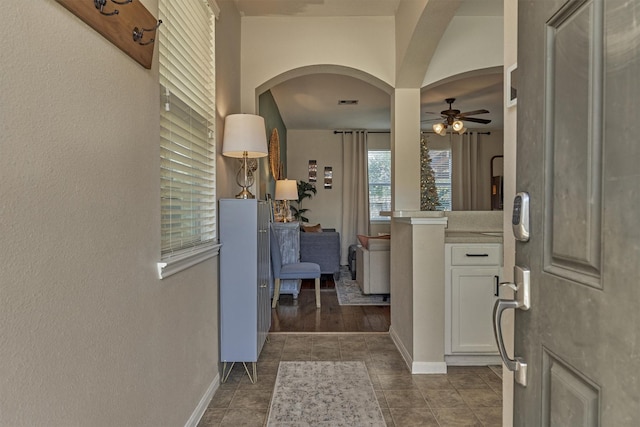 foyer with ceiling fan and dark wood-type flooring