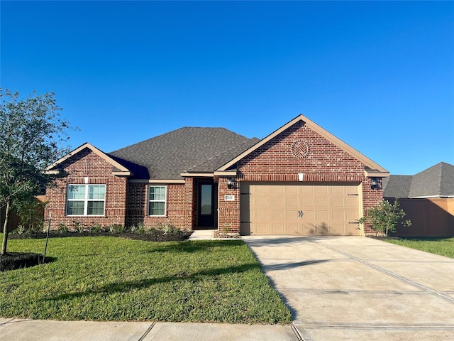 view of front of house featuring a garage and a front lawn