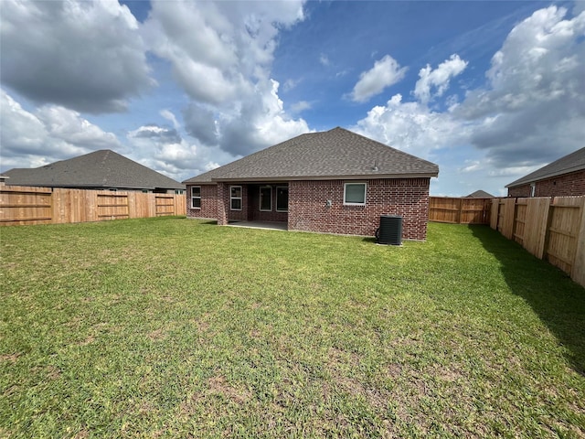 rear view of property featuring a patio, central AC unit, and a lawn