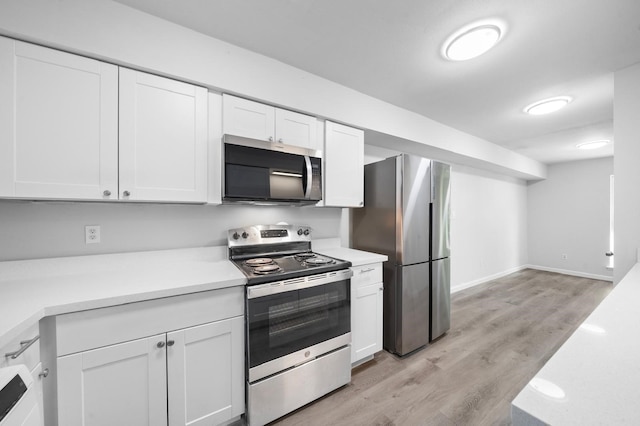 kitchen featuring white cabinetry, stainless steel appliances, and light hardwood / wood-style flooring