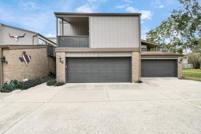 view of front of property with a garage and a balcony