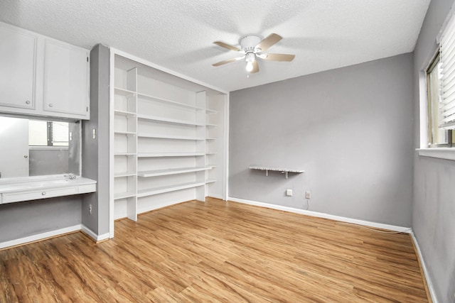 interior space featuring a wealth of natural light, a textured ceiling, and light wood-type flooring