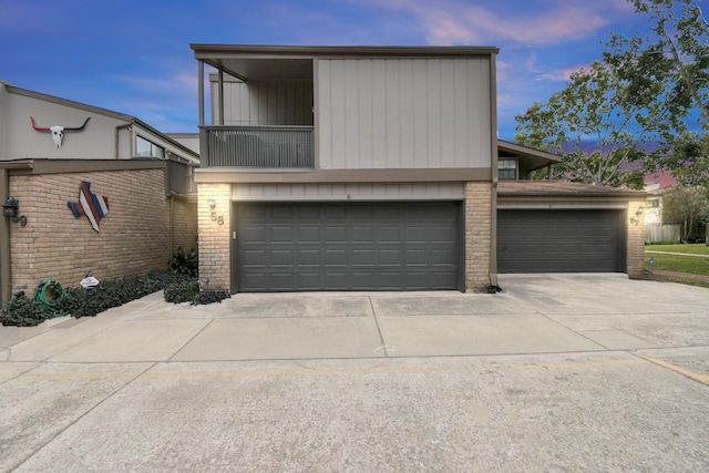 view of front of home featuring a garage and a balcony