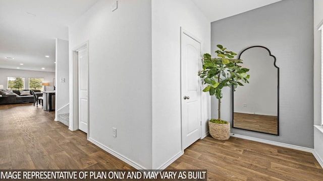 corridor with hardwood / wood-style flooring