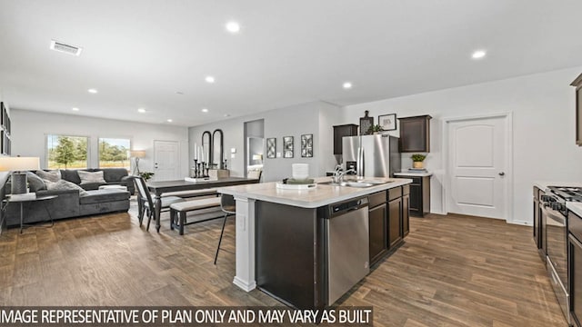 kitchen featuring a center island with sink, stainless steel appliances, dark hardwood / wood-style floors, and sink