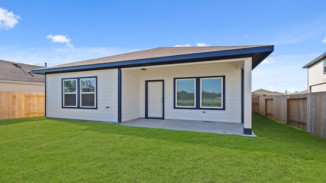 back of property featuring a yard and a patio area