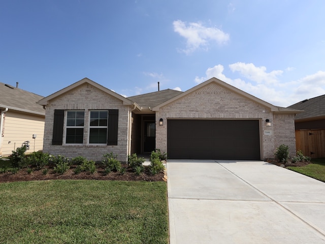 single story home featuring a front yard, brick siding, driveway, and a garage