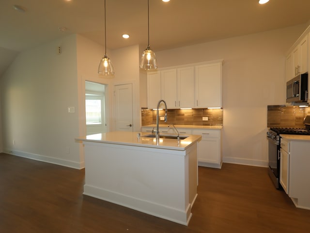 kitchen featuring stainless steel microwave, a sink, gas range, and backsplash