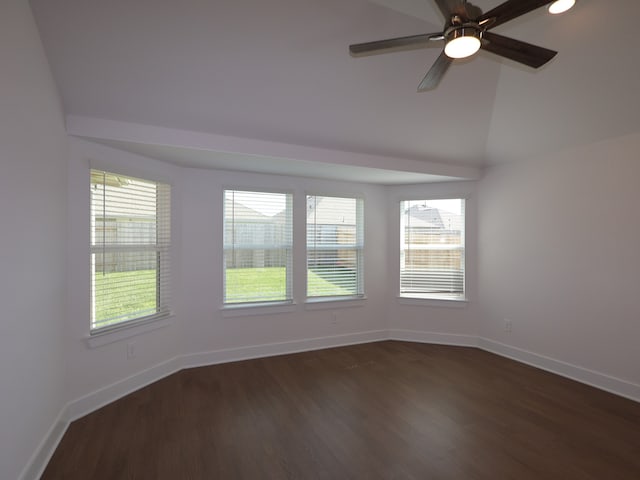 unfurnished room featuring a wealth of natural light, dark wood finished floors, and baseboards