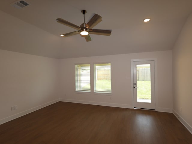 unfurnished room with baseboards, dark wood-style floors, a healthy amount of sunlight, and visible vents