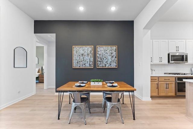 dining space with light hardwood / wood-style floors