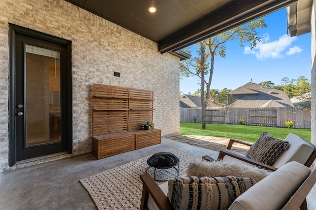 view of patio / terrace with an outdoor living space with a fire pit